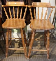 A pair of modern beech wood bar stools