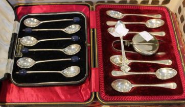 A cased set of six silver coffee spoons with sugar tongs, together with a cased set of silver coffee
