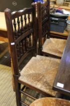 A set of four spindle back rush seated dining chairs in the Northern manner