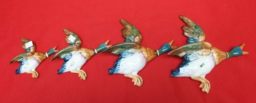 A set of four Beswick pottery flying duck wall ornaments, No.596-1,2,3 and 4, three still bear the l