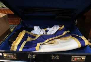 A black briefcase containing a selection of Masonic regalia