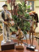 Three wooden figurines to include Don Quixote