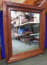 A substantial wall mirror with heavy pine frame