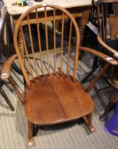 An Ercol bow spindle back rocking chair with splayed arms