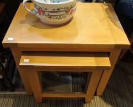 A modern beech wood set of two occasional tables