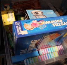 A box containing a wide selection of games and puzzles