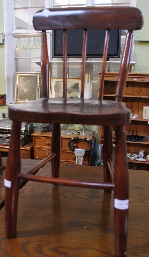 A child's spindle back wooden chair