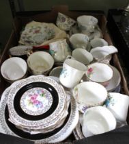 A box containing a wide selection of vintage dinner and tea wares