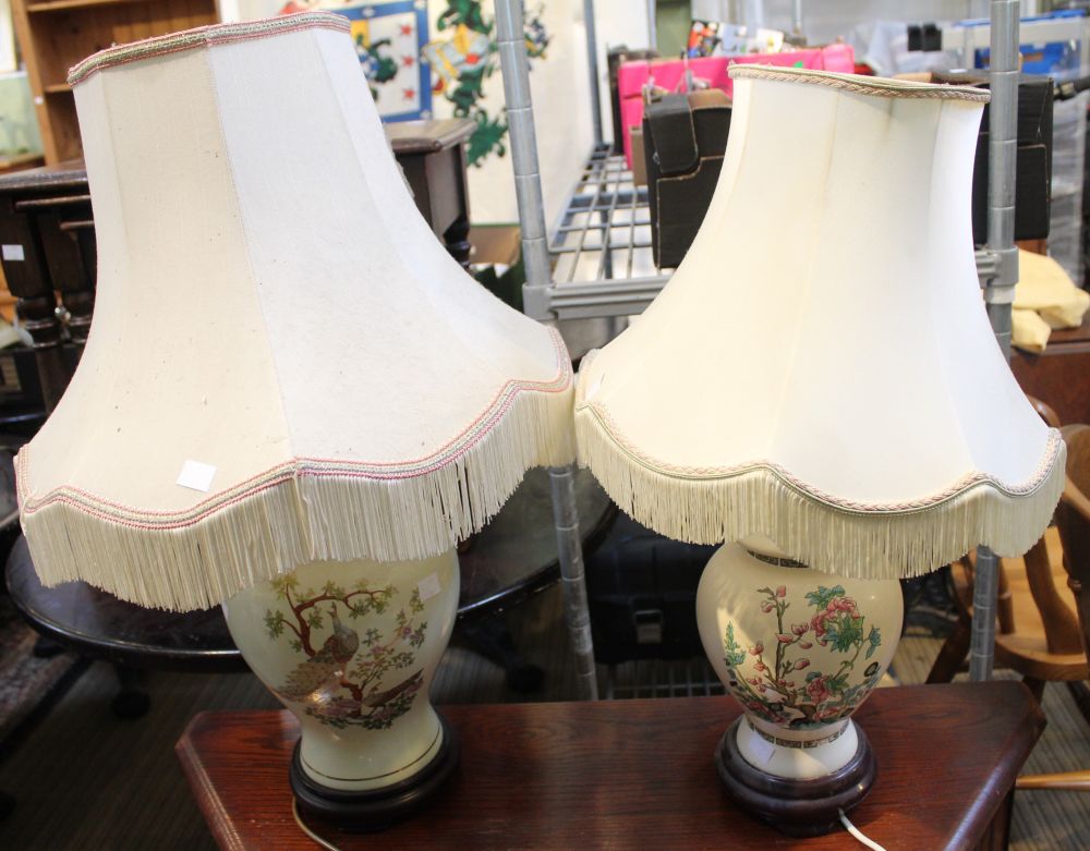 A pair of Oriental design lamps together with shades