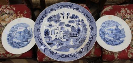 A large blue and white circular charger with two blue and white Wedgwood plates