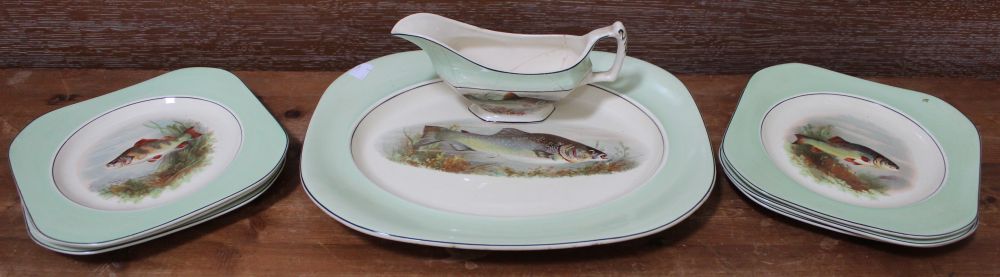 A selection of green plates with fish pattern together with a sauce boat, a/f