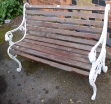 A wooden slatted garden bench with cast iron ends