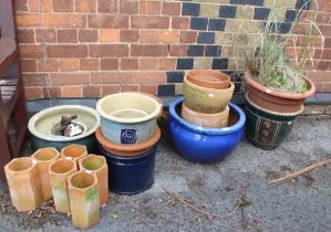 A large selection of garden pots, including terracotta and glazed examples