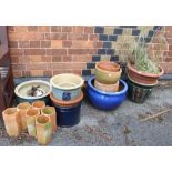 A large selection of garden pots, including terracotta and glazed examples