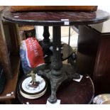 A cast iron tripod base wooden topped pub table 82 cm diameter top
