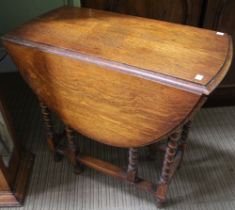 An oak gateleg table with barley twist legs