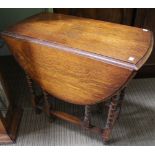 An oak gateleg table with barley twist legs