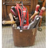 A wooden tub containing a selection of hand tools various
