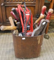 A wooden tub containing a selection of hand tools various