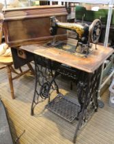 A manual Singer sewing machine with treadle table