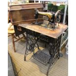 A manual Singer sewing machine with treadle table