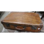 A substantial tan coloured suitcase