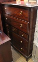 A tall Stag chest of seven drawers, with brass handles