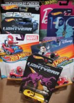 A collection of ten Hot Wheels vehicles, includes Spiderman, Barbie etc, in original blister packs (