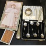 Two hallmarked silver photograph frames, a case containing five silver coffee bean spoons, silver ha