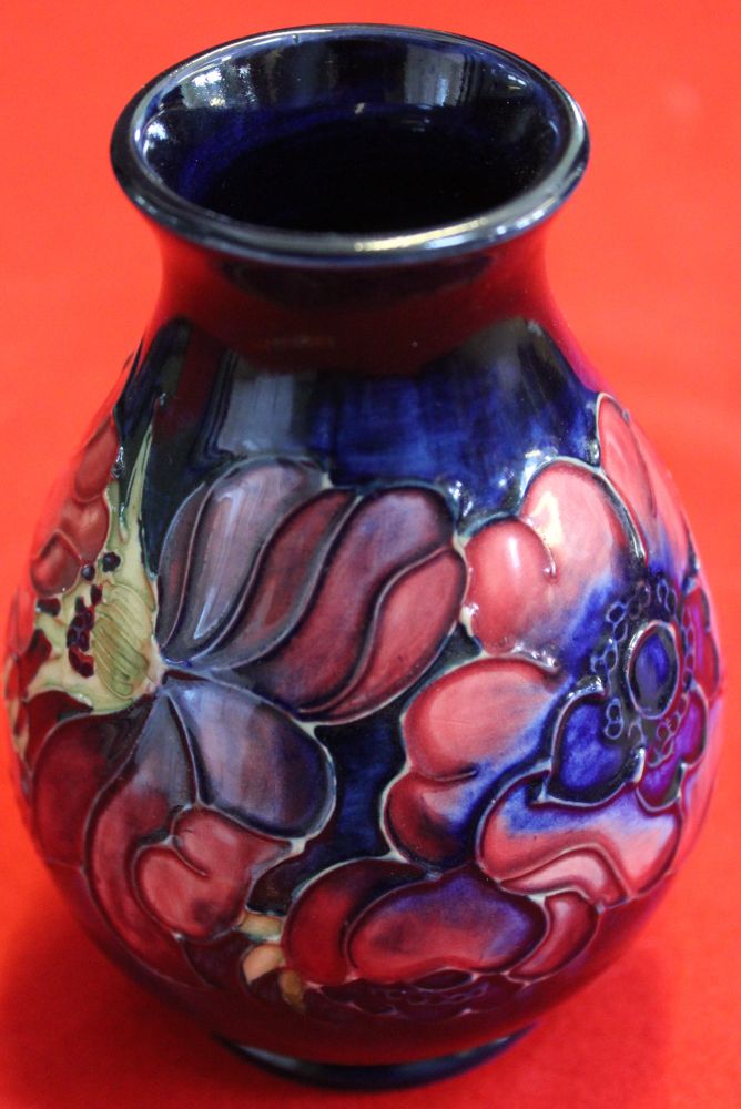 A Moorcroft pottery vase of baluster form, tube lined and painted Anemone design on a blue ground, 1