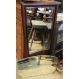 A mid century clip frame wall mirror, with a wooden framed rectangular wall mirror