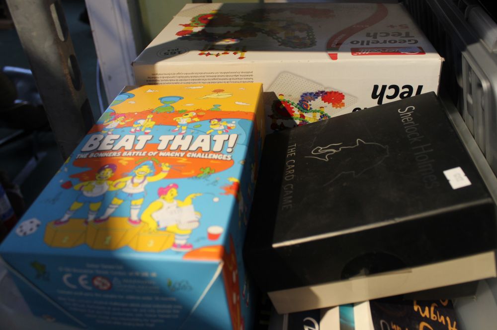 A box containing children's games, paperback books, etc.