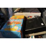 A box containing children's games, paperback books, etc.