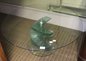 A low circular glass coffee table