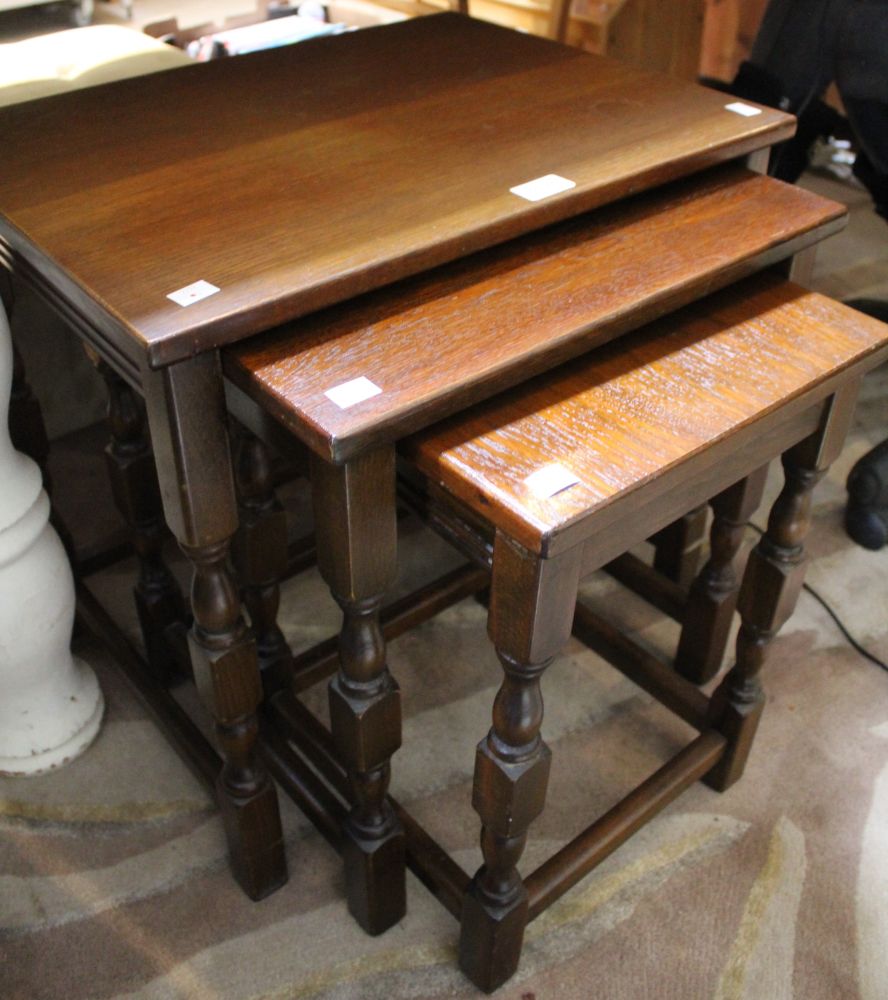 A dark wood nest of three tables