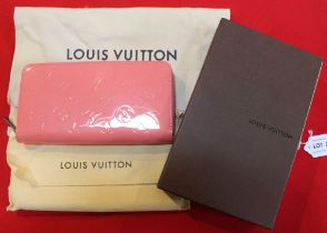 A Louis Vuitton zip around ladies wallet, in patent pink "Alma Poppy" colour, in original bag and bo