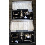 Two individually cased silver condiment sets of Georgian design, comprising pepper pots, salts and l