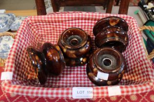 A set of four treacle glazed earthenware table/chair risers
