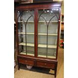 An Edwardian mahogany display cabinet, glazed and two drawers to the base