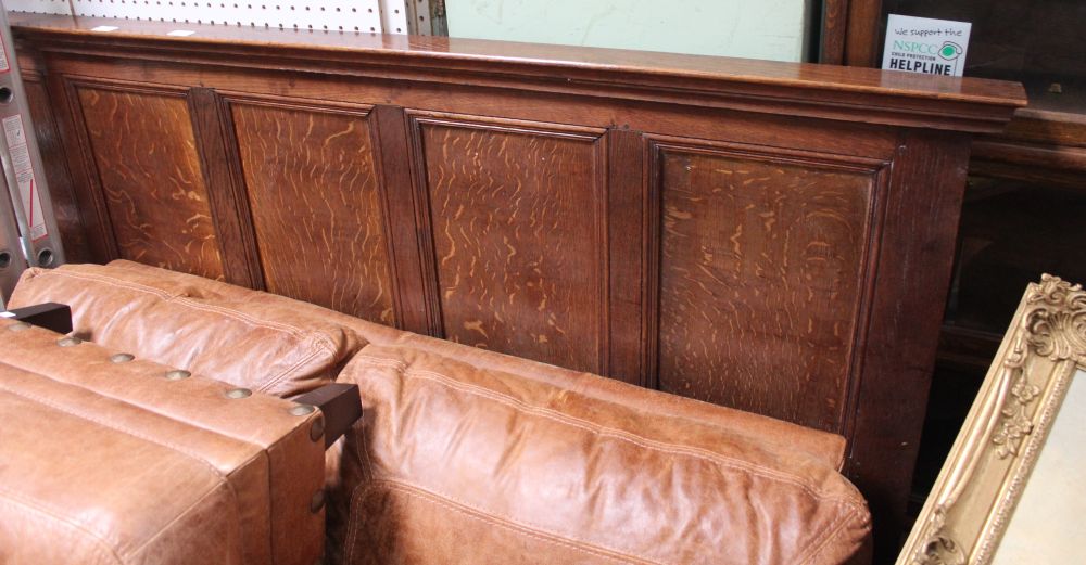 A piece of 19th century oak panelling previously deployed as a head board
