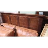 A piece of 19th century oak panelling previously deployed as a head board