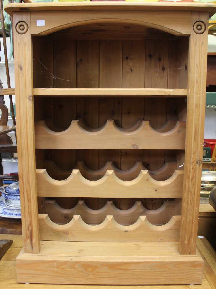 A pine open cupboard with shelf and wine racks below