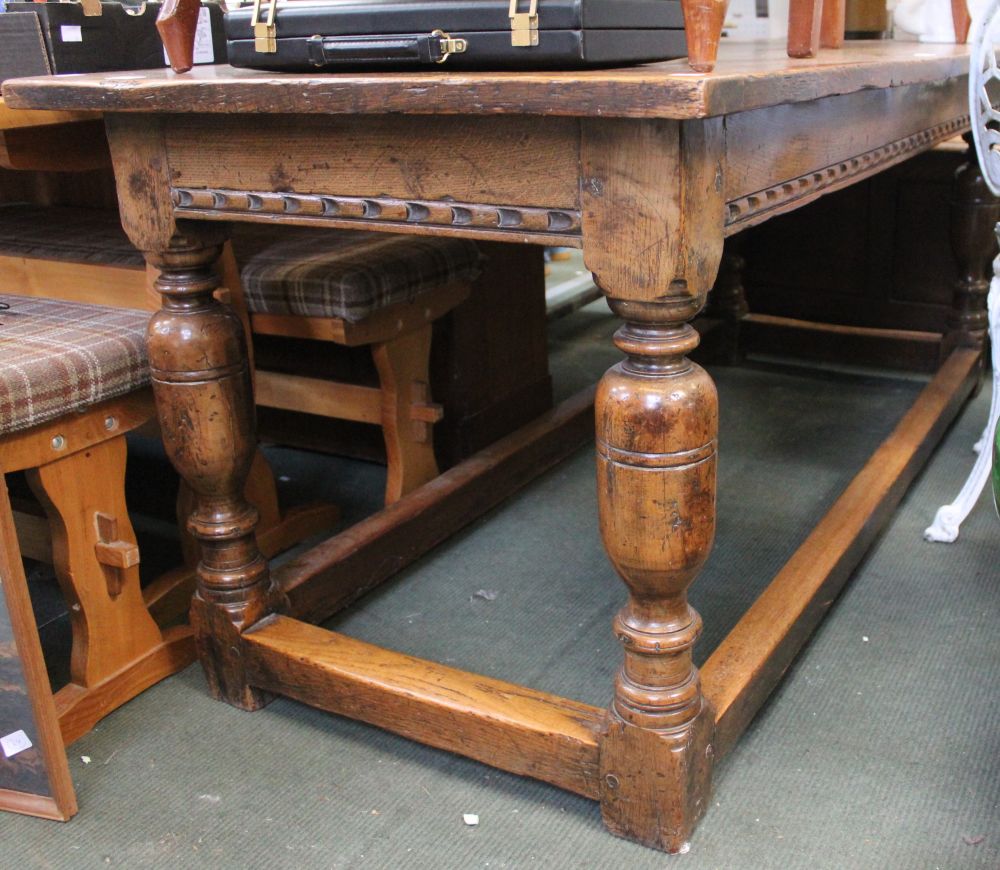 A 19th century oak three plank refectory table with cleated ends on turned legs &