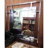 A large square modern metal framed wall mirror