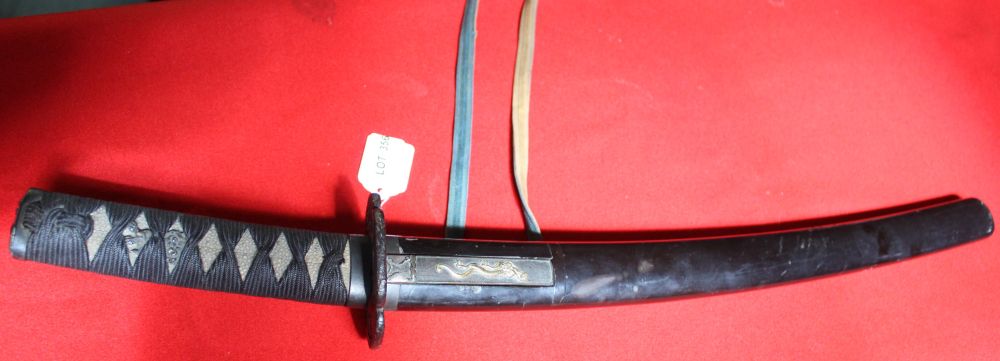 A Japanese sword with shagreen handle cord wrapped. Cast Tsuba. the lacquer scabbard inset small