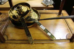 A pair of 19th century Dutch brass chamber sticks, chased decoration, together with a copper frying