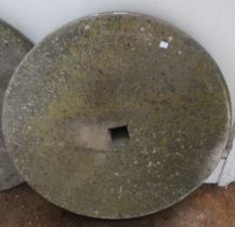 An old circular mill stone 76 cm diameter