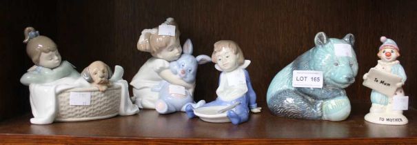 A shelf to include three Nao figurines and two Beswick examples (5)
