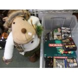 A large storage box containing a selection of CD's, DVD's and a plush Xmas reindeer