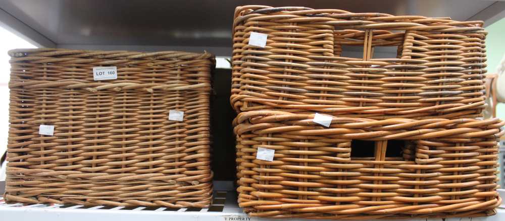 A shelf containing five wicker baskets